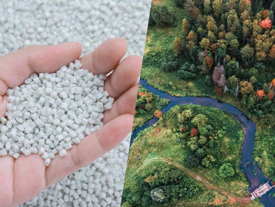 Figure of a hand, holding recycled plastic granulate near a green landscape